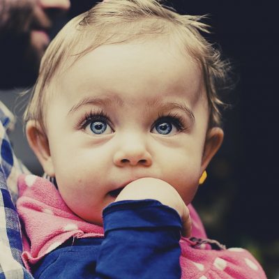 Young girl held by father