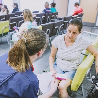 nurse is consulting a patient