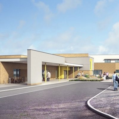 Yellow and orange brick building with people outside.