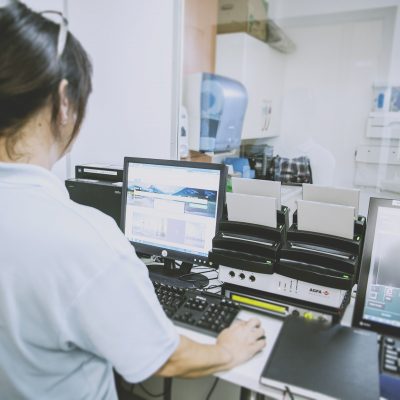 Woman is working on a piece of high tech equipment