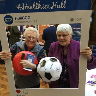 Elderly ladies posing for photo