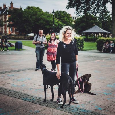 Lady and two dogs in a park