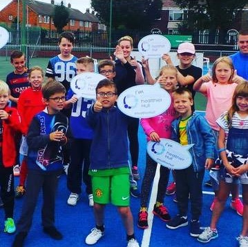 Young children holding Healthier Hull signs