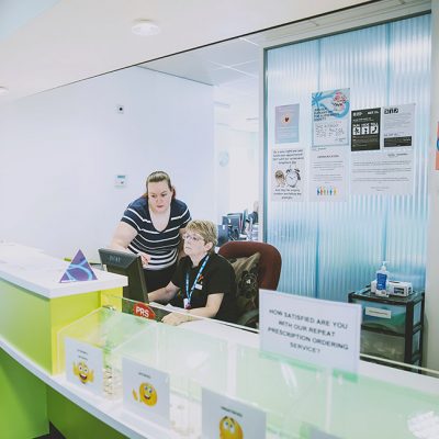 Receptionist speaking with colleague