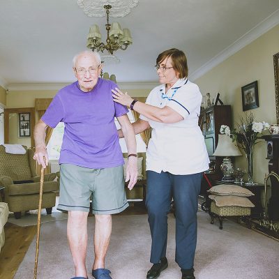 Carer helping patient