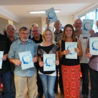 Champions holding up posters