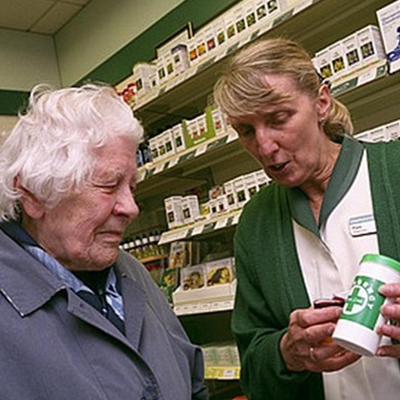 Pharmacist helping eldery lady